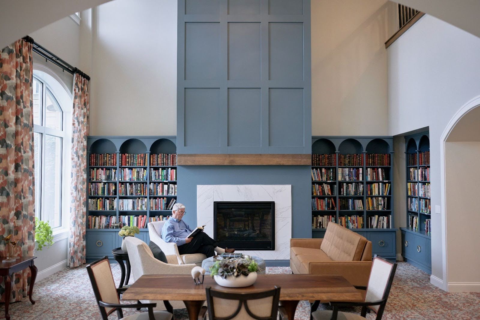 Elderly man reading in a library 