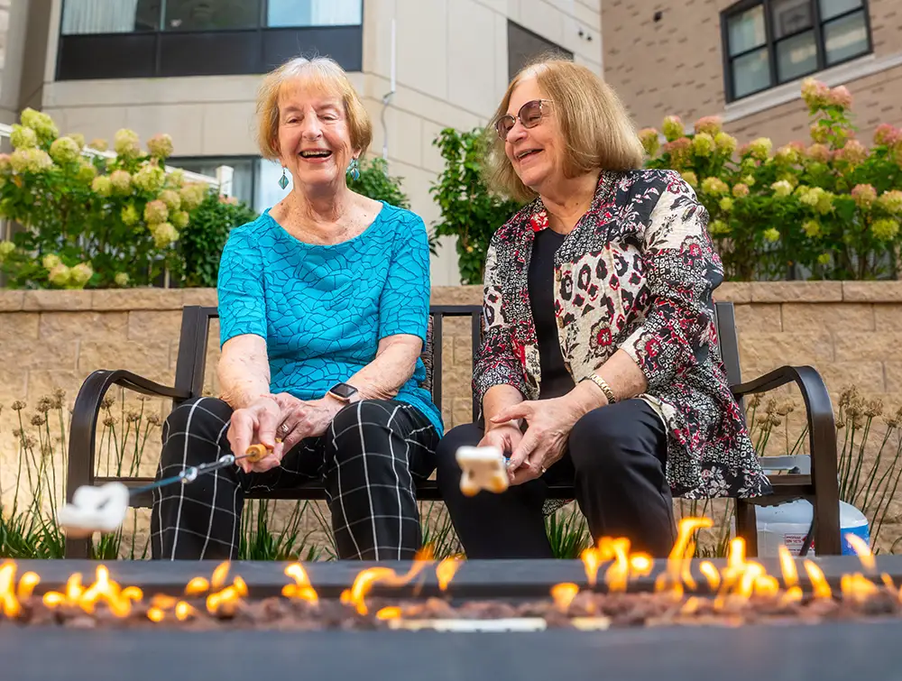 Senior women roasting marshmallows