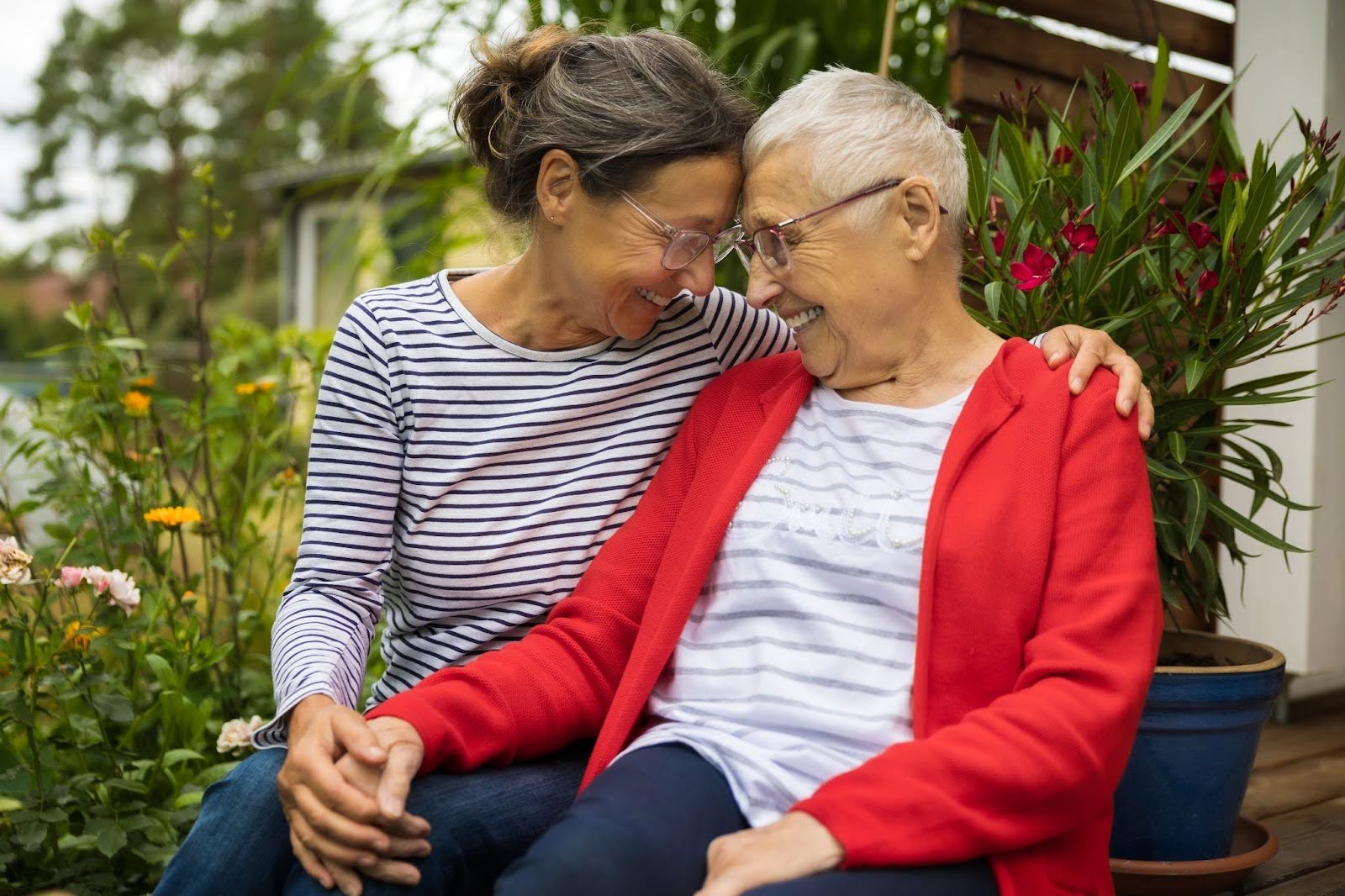 senior mom and daughter smiling forehead to forehead